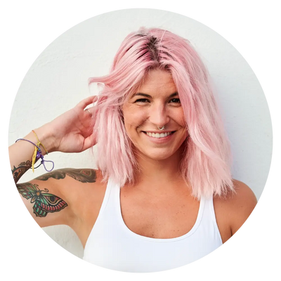 woman with pink hair smiling for the camera
