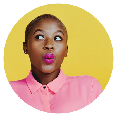 woman with short hair and purple lipstick wearing a pink collared shirt