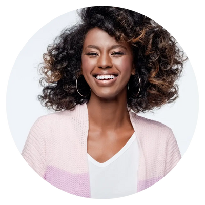 woman smiling in a white shirt and pink sweater