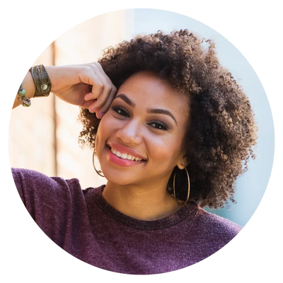 woman in a purple sweater smiling for the camera
